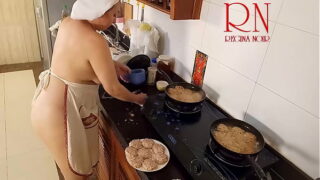 Nudist housewife Regina Noir cooks at the kitchen